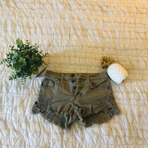 Army green shorts with cute detail on sides!